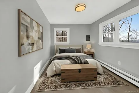 a bedroom with a bed and a painting on the wall