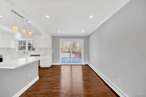a view of kitchen with sink and wooden floor