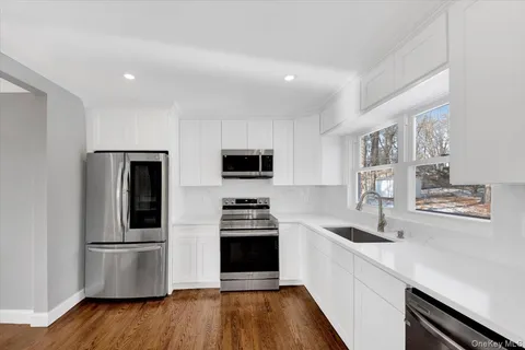 a kitchen with stainless steel appliances a refrigerator and a stove top oven
