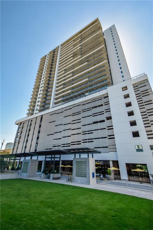 222 West Avenue, Unit 2207 Austin, TX 78701 - Photo 14 of 30 Modern high-rise residential building with a contemporary facade featuring multiple balconies and a street-level retail presence