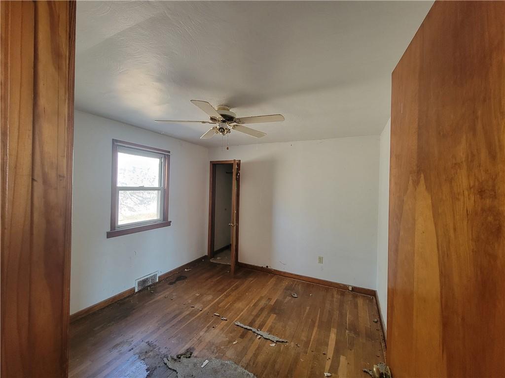 343 Thomas Street Carnegie, PA 15106 - Photo 4 of 9 a view of an empty room with wooden floor and a window