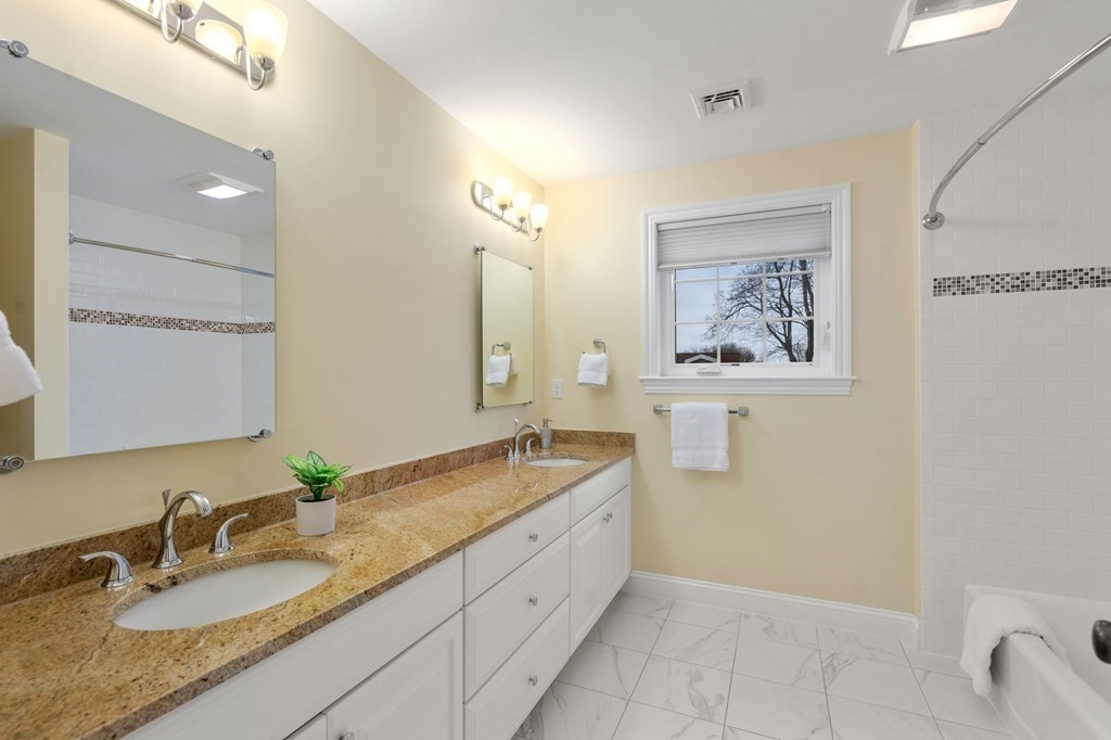 24 Crescent Road, Unit 1 Needham, MA 02494 - Photo 12 of 20 a bathroom with a granite countertop sink and a mirror