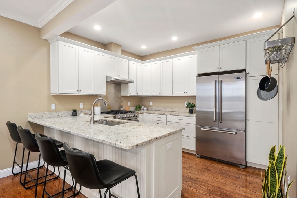 24 Crescent Road, Unit 1 Needham, MA 02494 - Photo 4 of 20 a kitchen with stainless steel appliances granite countertop a sink a stove a refrigerator and cabinets