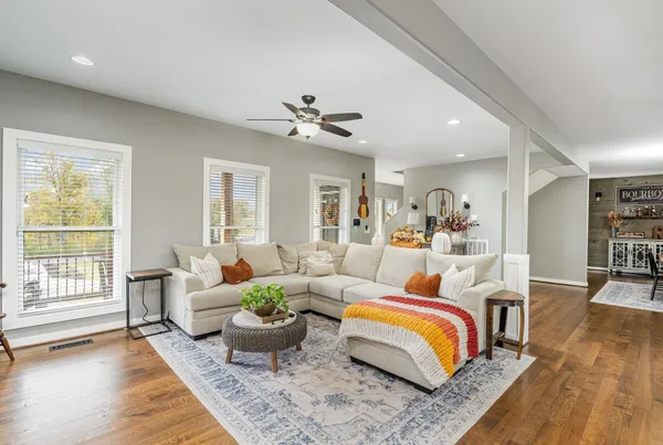 a living room with furniture and wooden floor