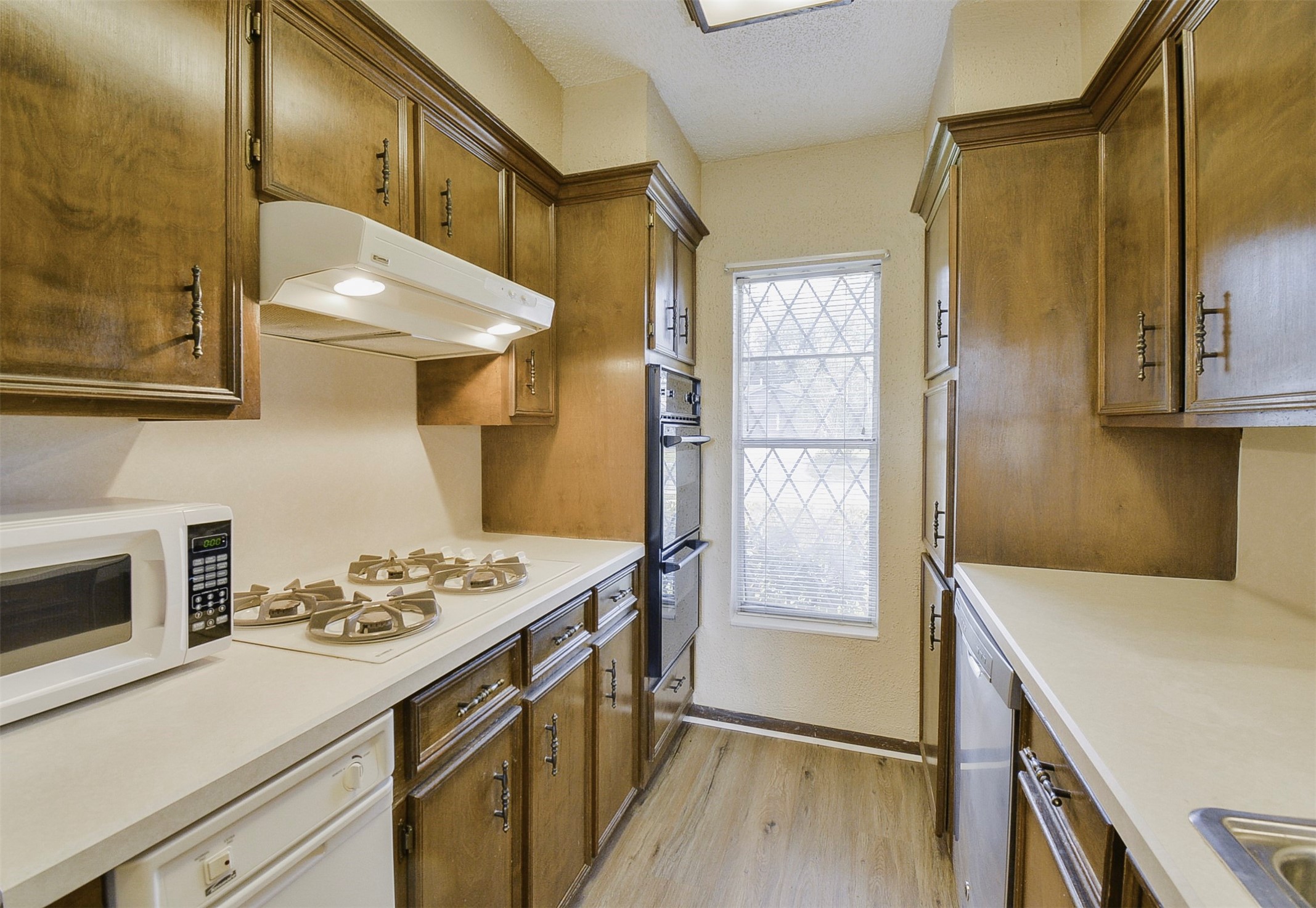 13915 Roundstone Lane Houston, TX 77015 - Photo 14 of 42 a kitchen with a stove and a refrigerator