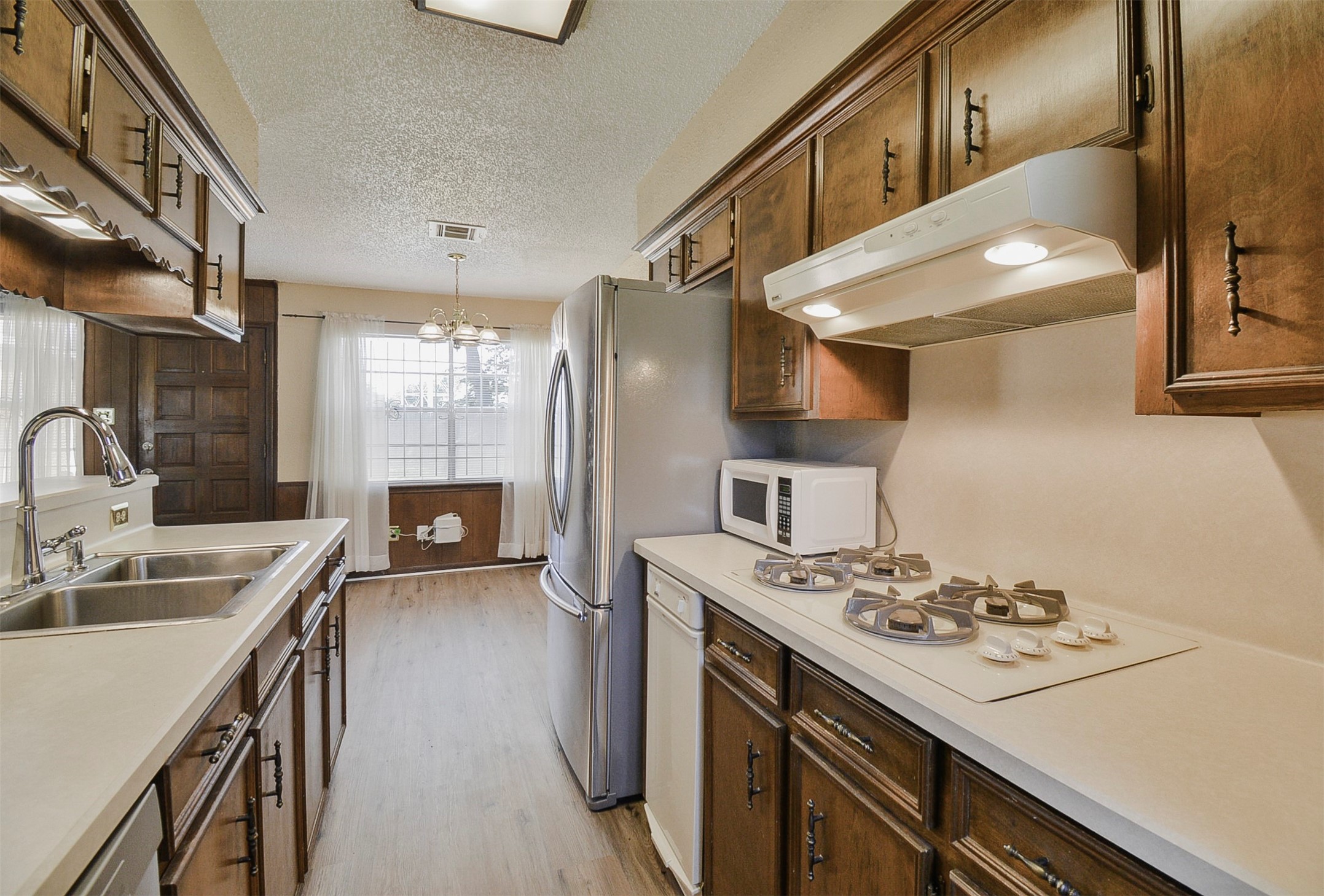 13915 Roundstone Lane Houston, TX 77015 - Photo 16 of 42 a kitchen that has a sink a stove and a refrigerator