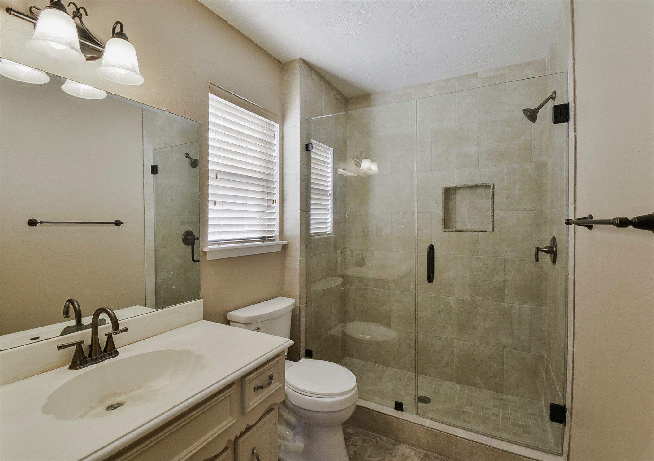 13915 Roundstone Lane Houston, TX 77015 - Photo 30 of 42 a bathroom with a sink toilet and shower