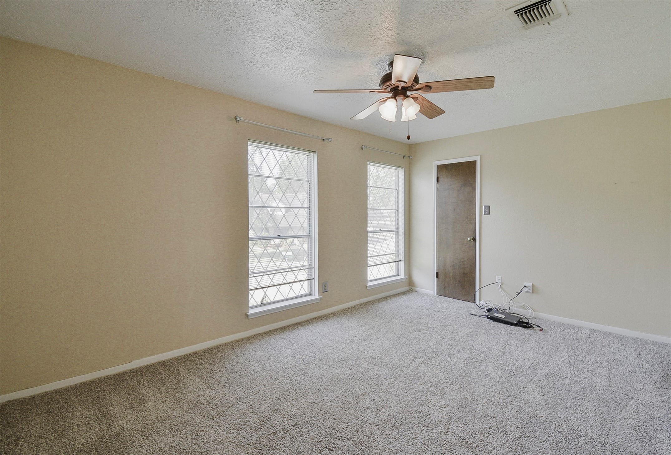 13915 Roundstone Lane Houston, TX 77015 - Photo 33 of 42 an empty room with windows and fan