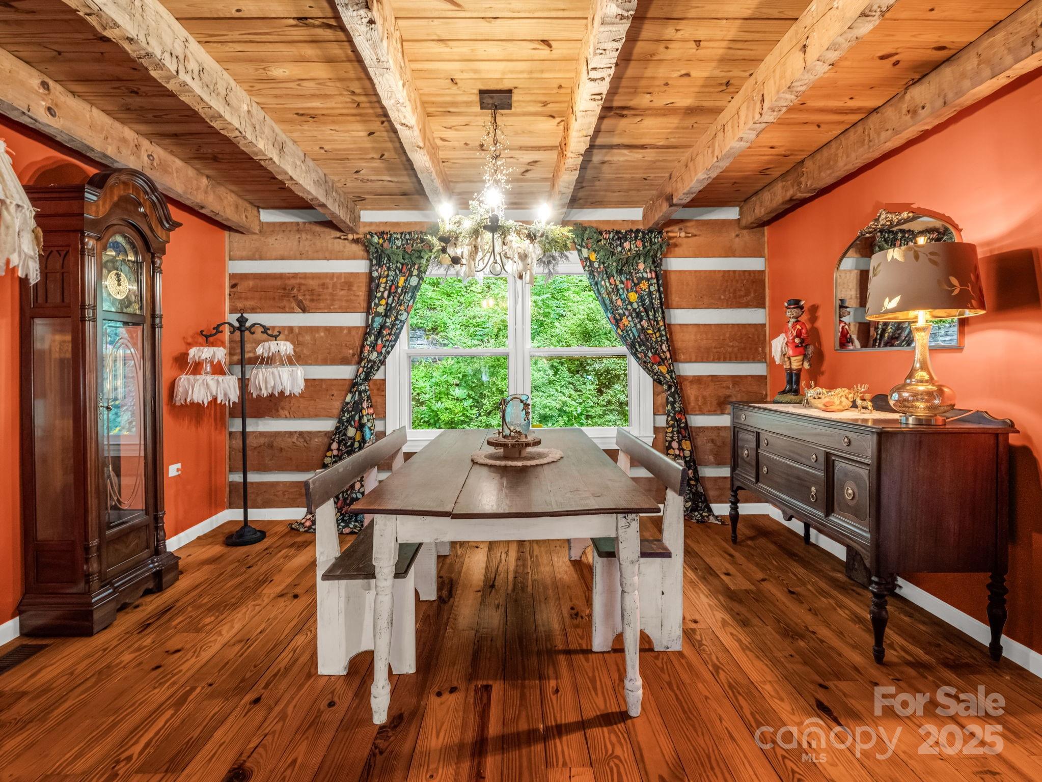 1145 Bearwallow Mountain Road Hendersonville, NC 28792 - Photo 12 of 48 a view of a patio with table and chairs with wooden floor and fence