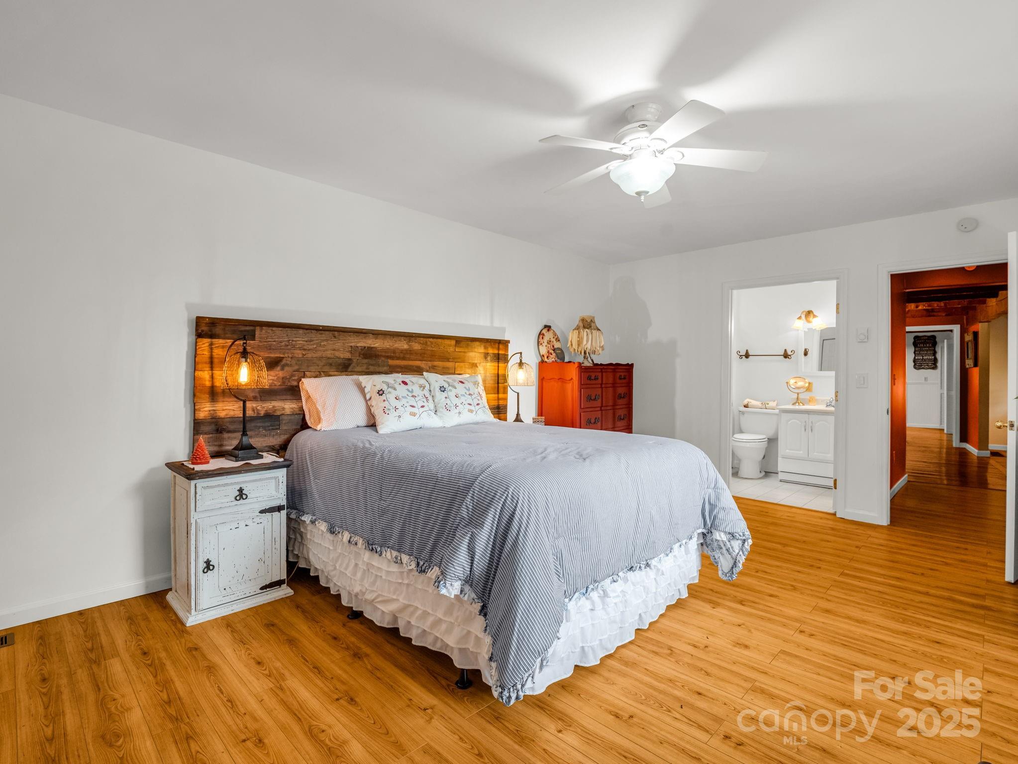 1145 Bearwallow Mountain Road Hendersonville, NC 28792 - Photo 15 of 48 a bedroom with a bed and wooden floor