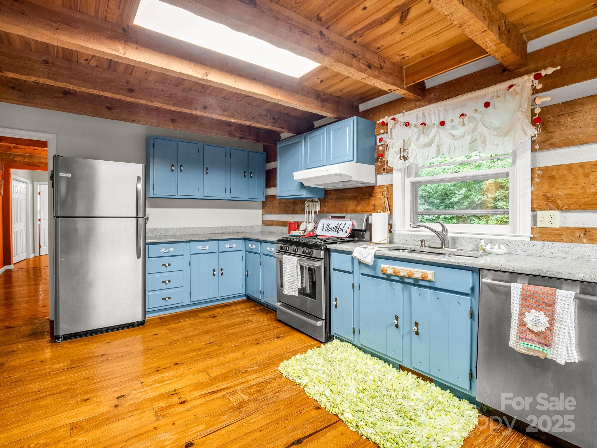 1145 Bearwallow Mountain Road Hendersonville, NC 28792 - Photo 19 of 48 a kitchen with stainless steel appliances granite countertop a sink stove and refrigerator