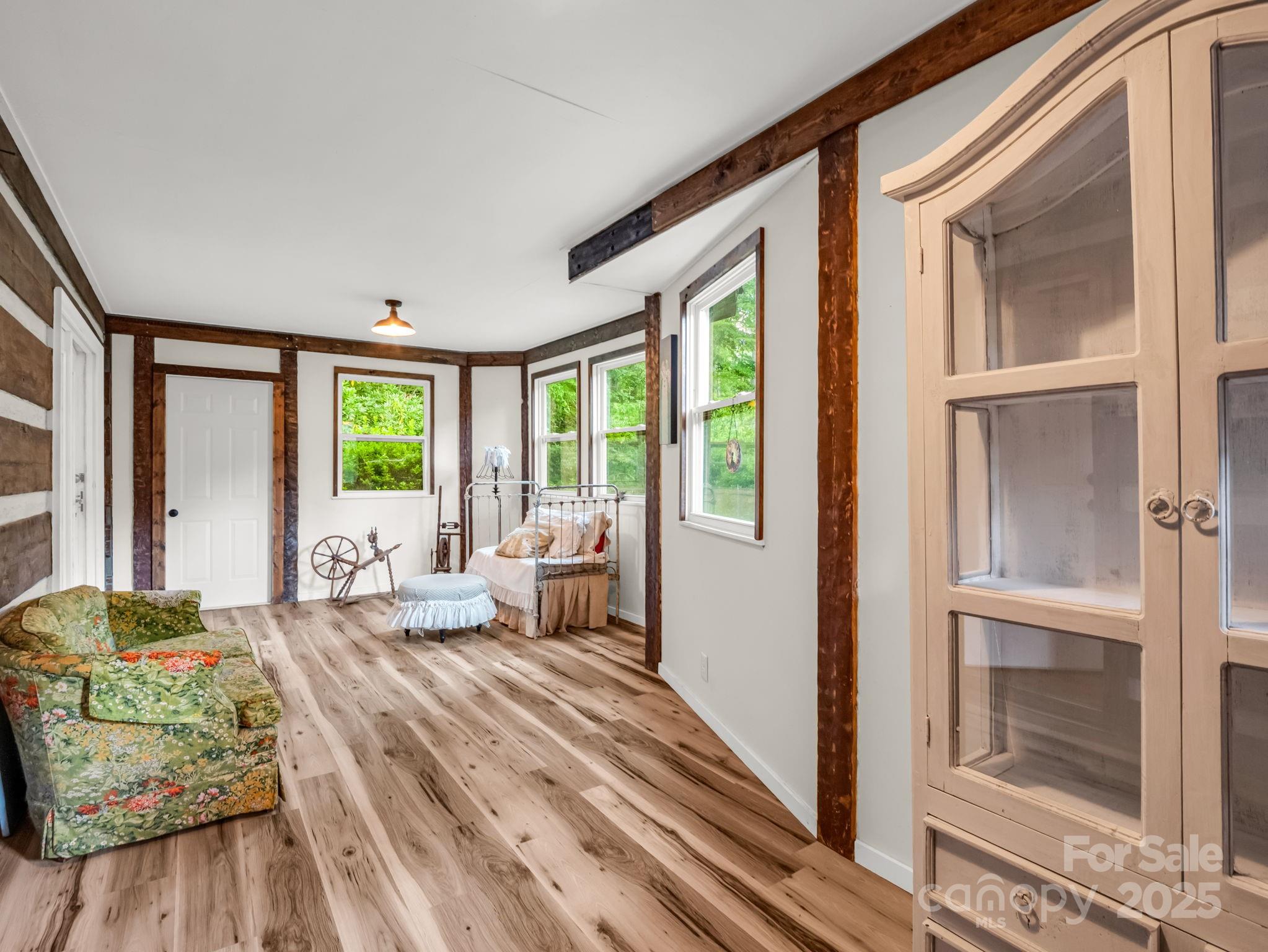 1145 Bearwallow Mountain Road Hendersonville, NC 28792 - Photo 24 of 48 a bedroom with furniture and large windows