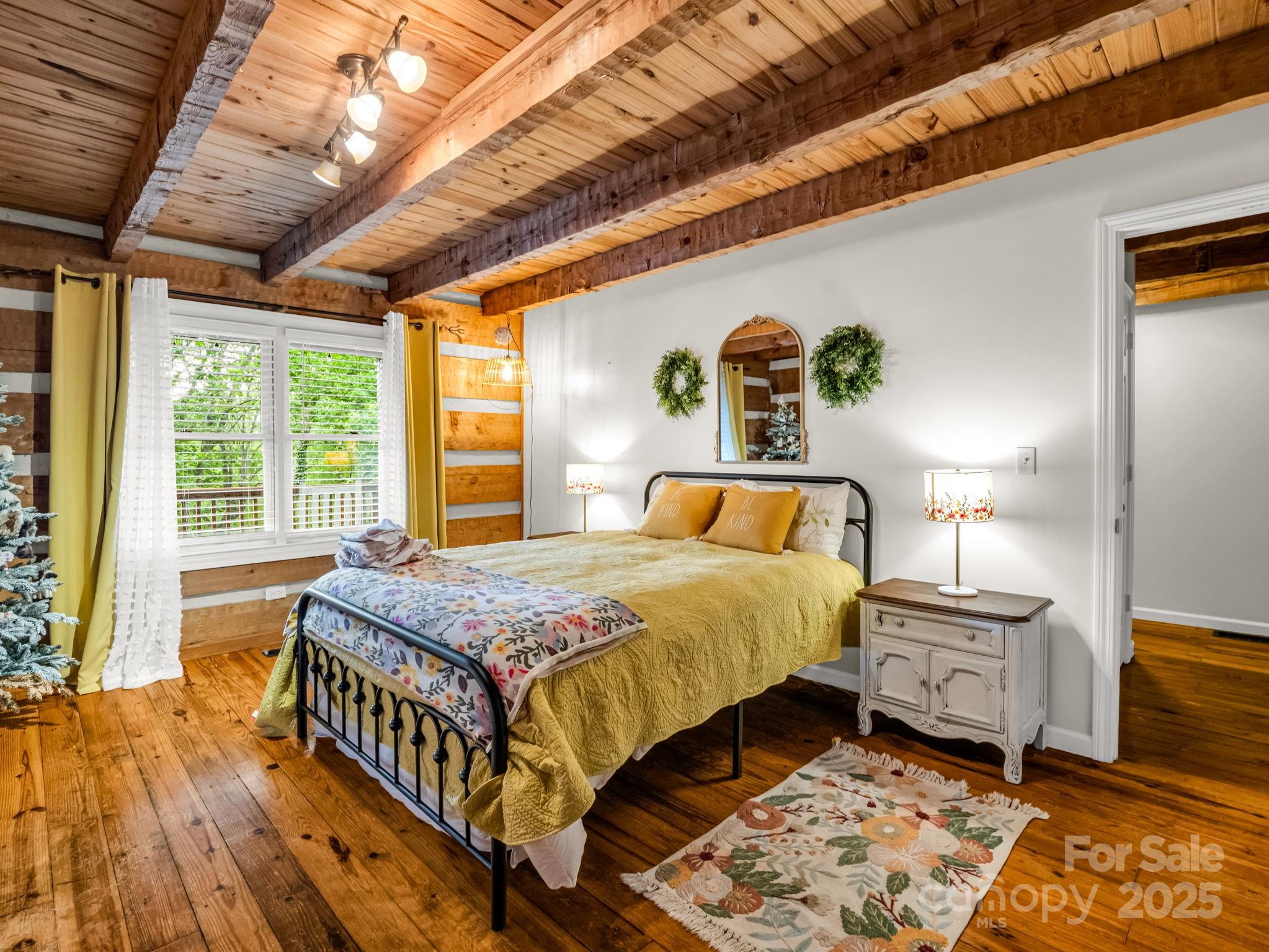 1145 Bearwallow Mountain Road Hendersonville, NC 28792 - Photo 25 of 48 a bedroom with a bed and a window