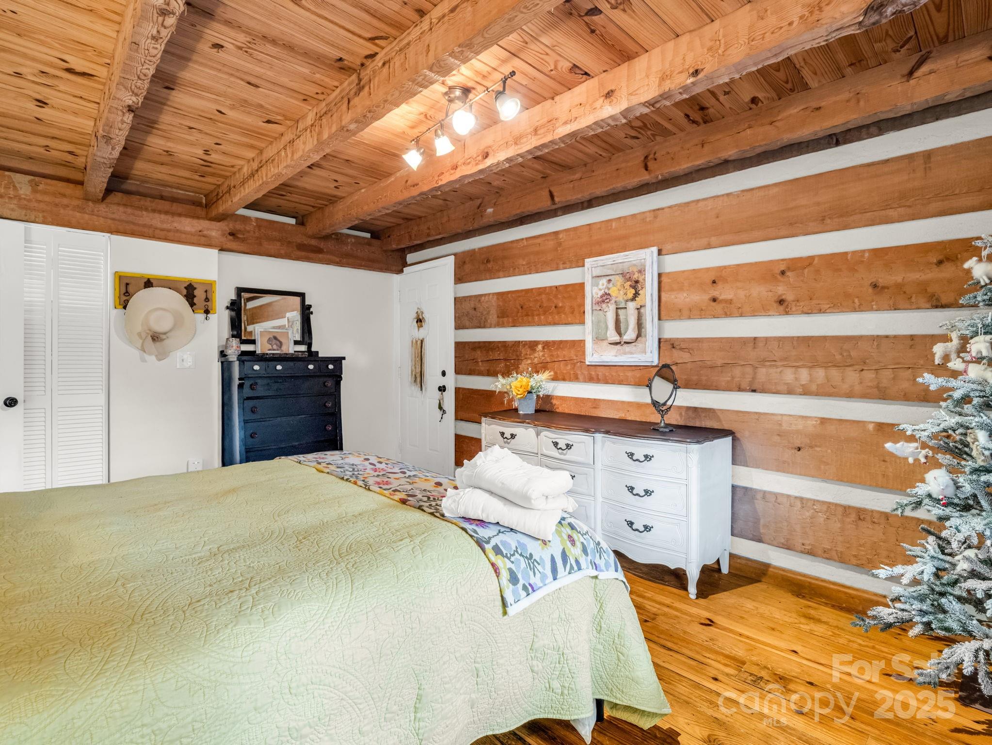 1145 Bearwallow Mountain Road Hendersonville, NC 28792 - Photo 26 of 48 a bedroom with a bed and cabinets