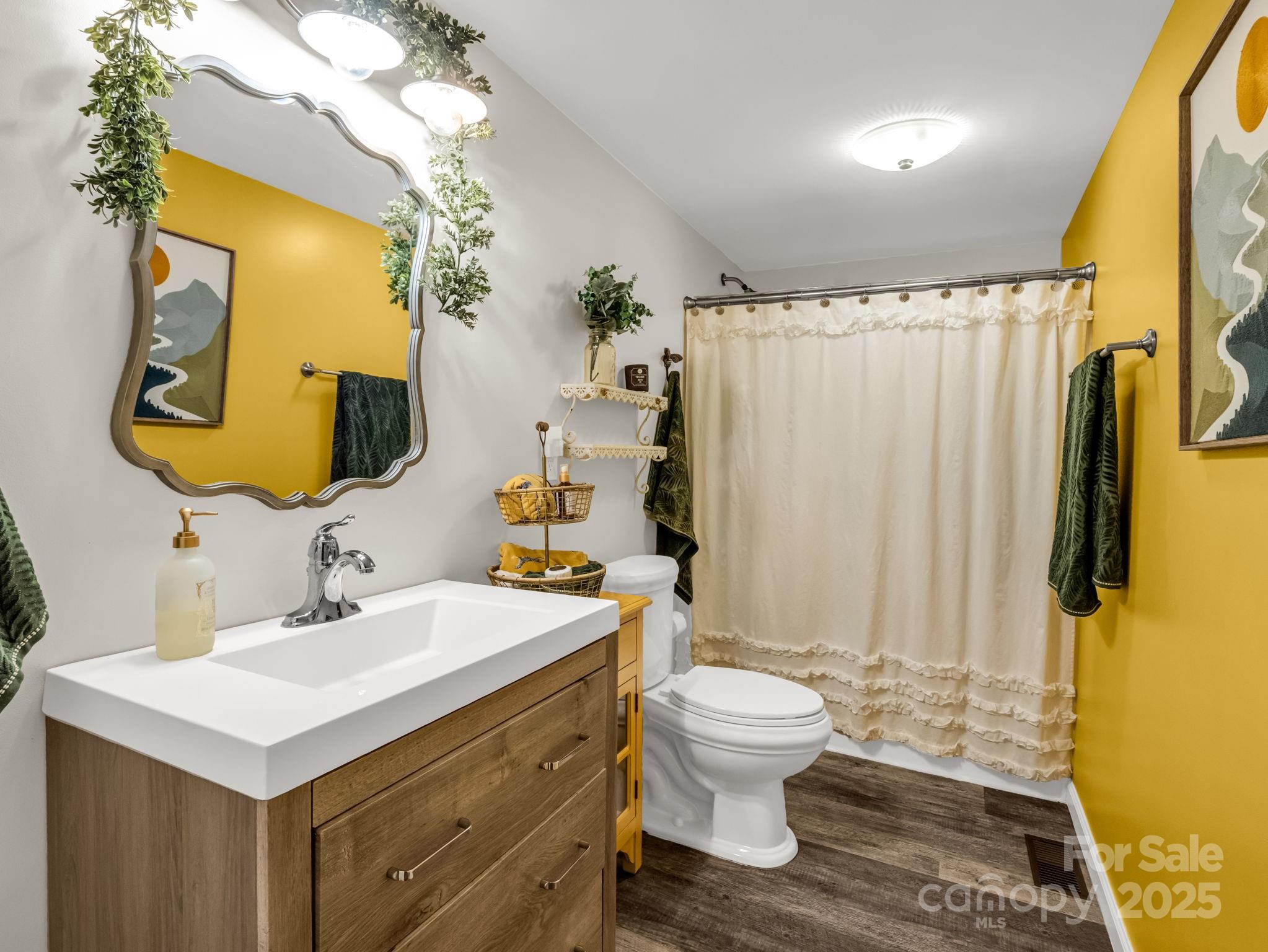 1145 Bearwallow Mountain Road Hendersonville, NC 28792 - Photo 27 of 48 a bathroom with a sink toilet and shower