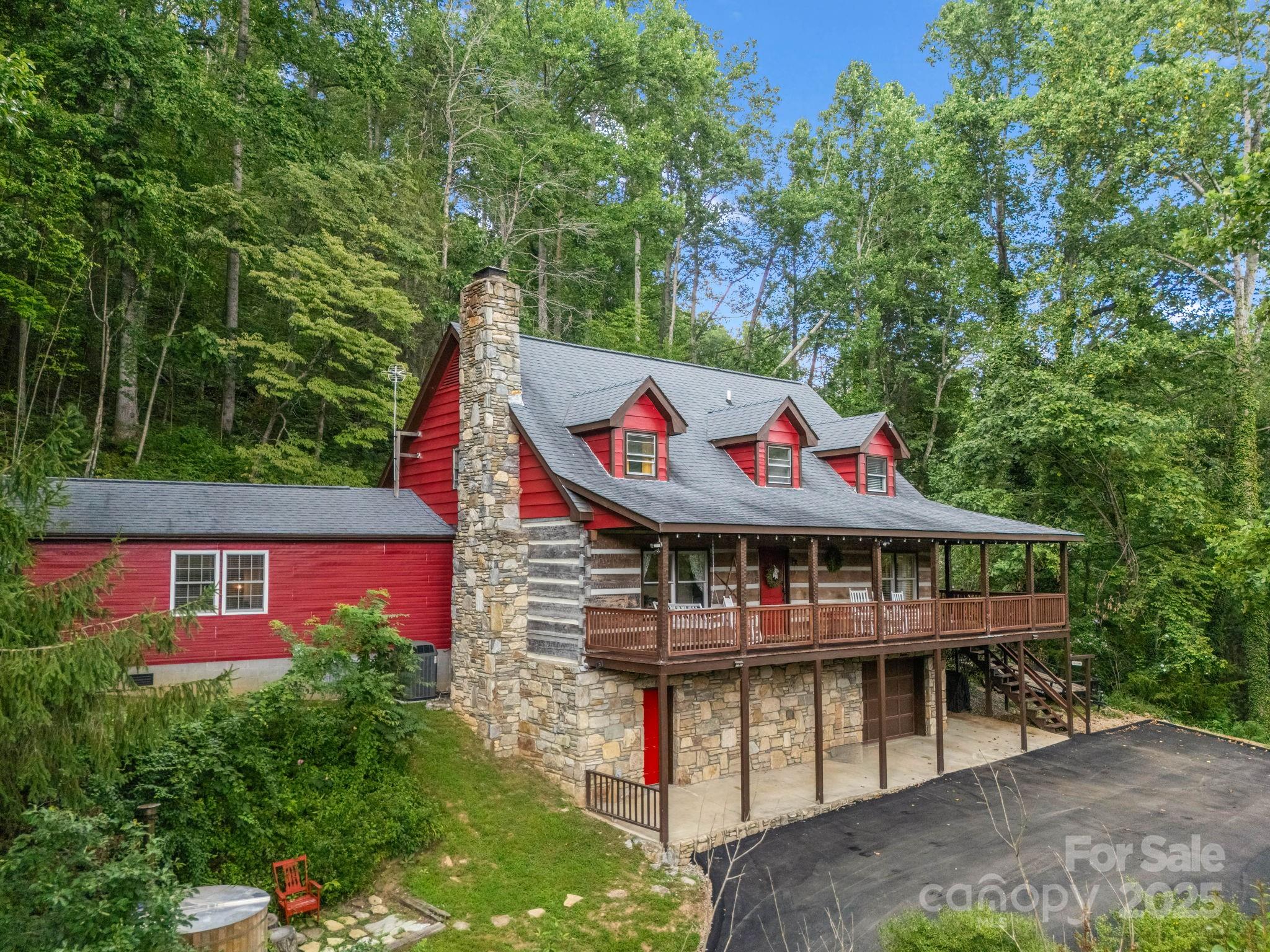 1145 Bearwallow Mountain Road Hendersonville, NC 28792 - Photo 3 of 48 aerial view of a house with swimming pool and trees in the background