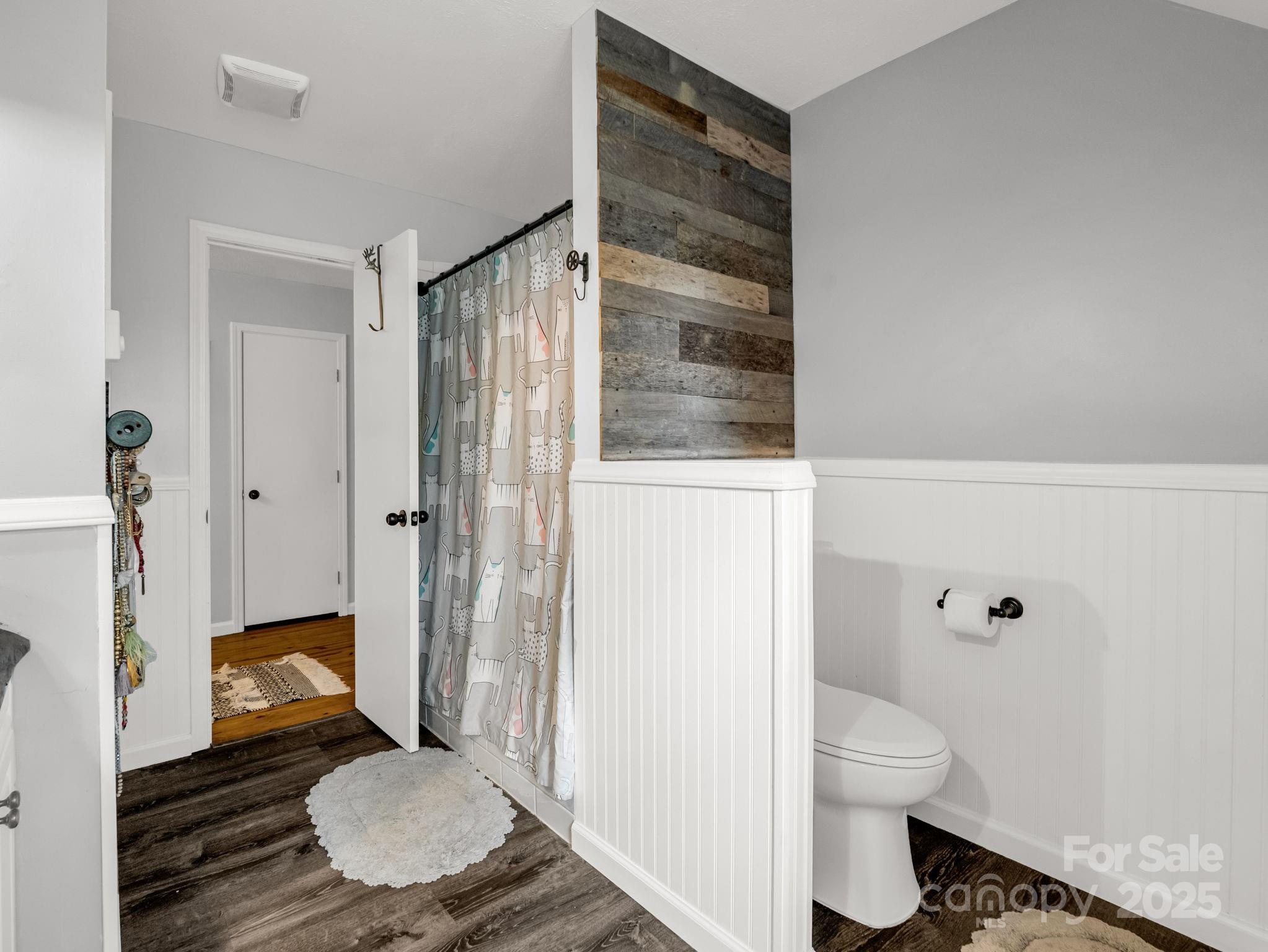 1145 Bearwallow Mountain Road Hendersonville, NC 28792 - Photo 33 of 48 a bathroom with a granite countertop toilet and a shower