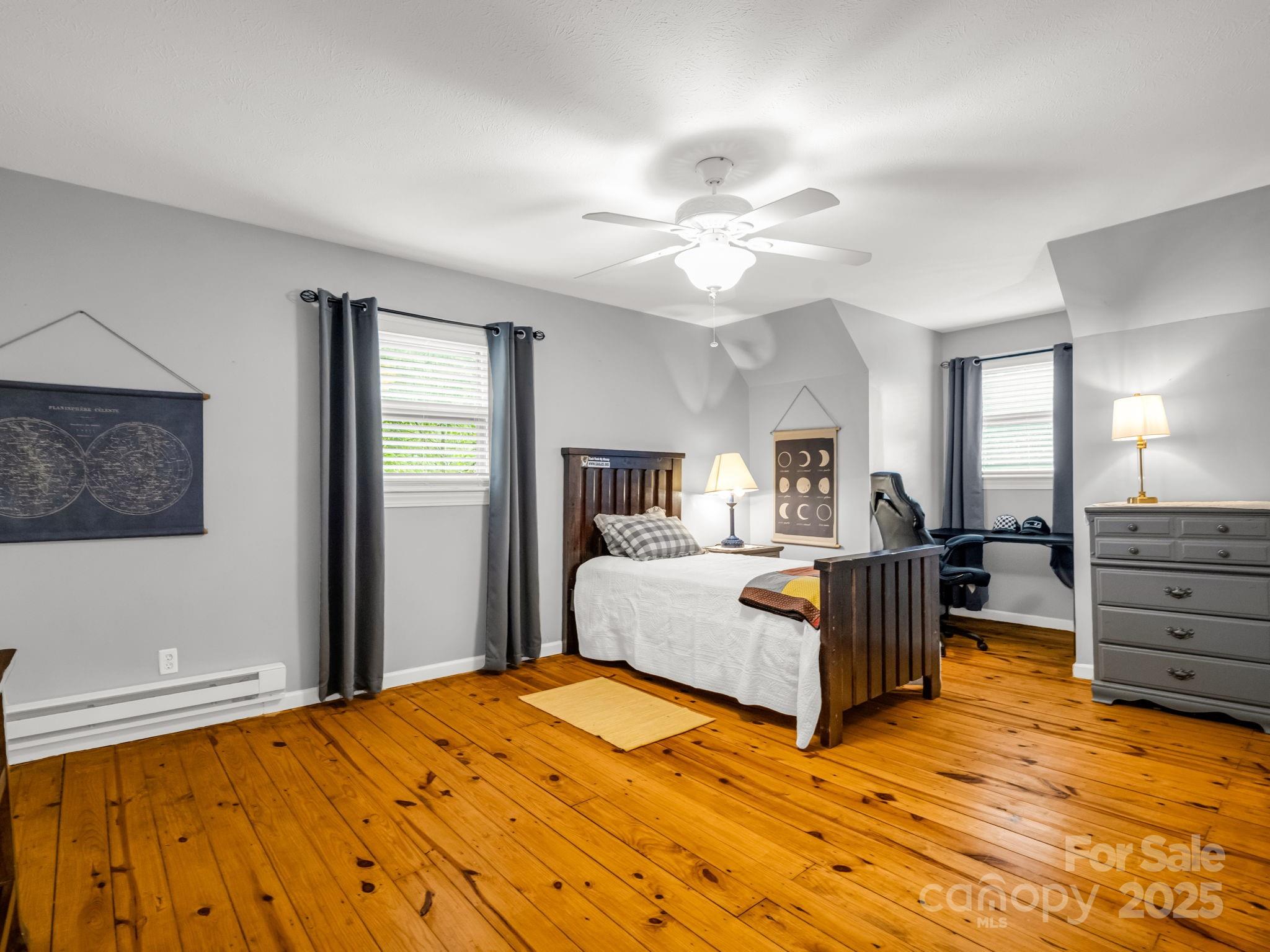 1145 Bearwallow Mountain Road Hendersonville, NC 28792 - Photo 34 of 48 a bed room with a bed and a chandelier