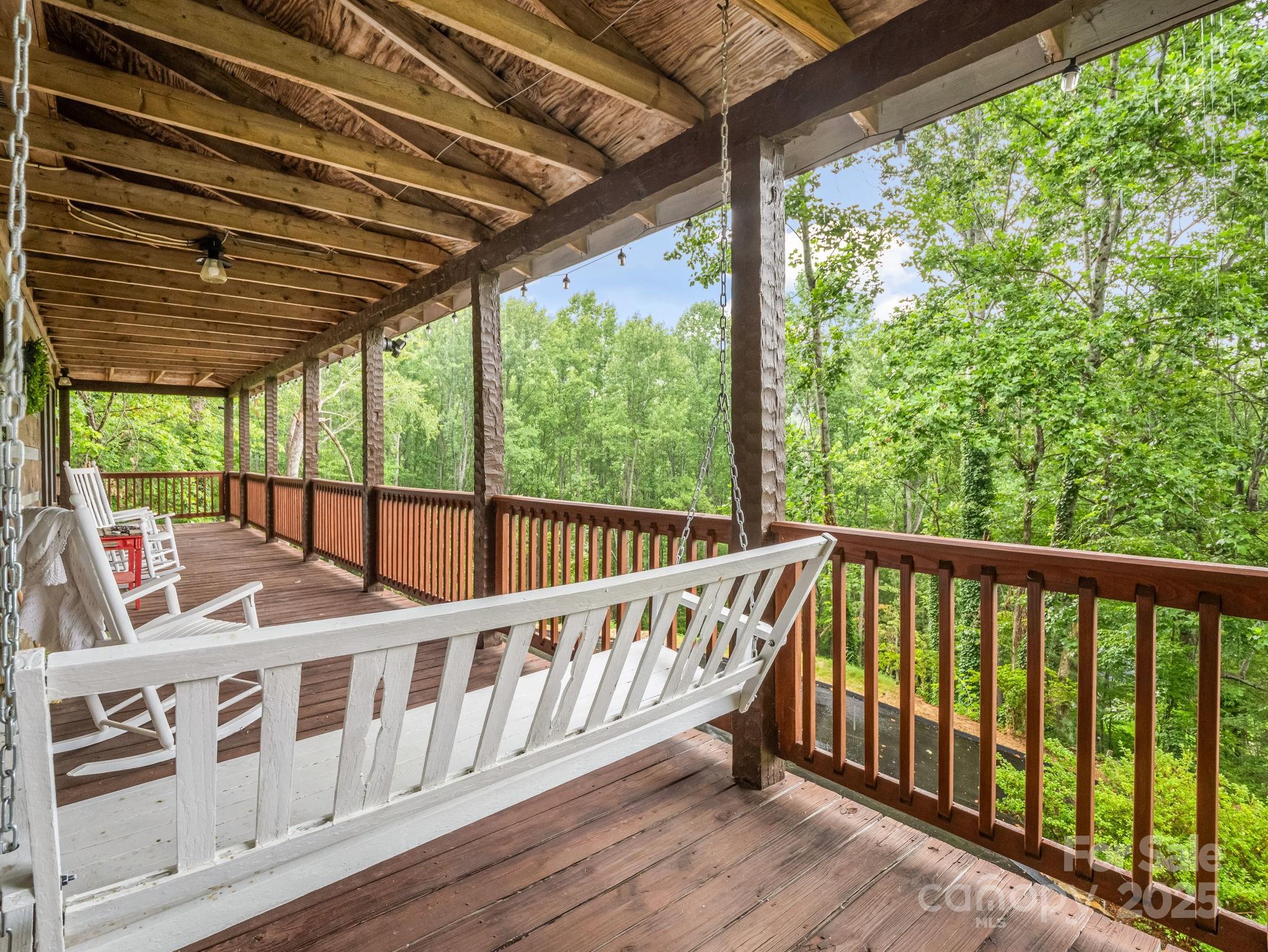 1145 Bearwallow Mountain Road Hendersonville, NC 28792 - Photo 6 of 48 a view of a wooden deck with a yard