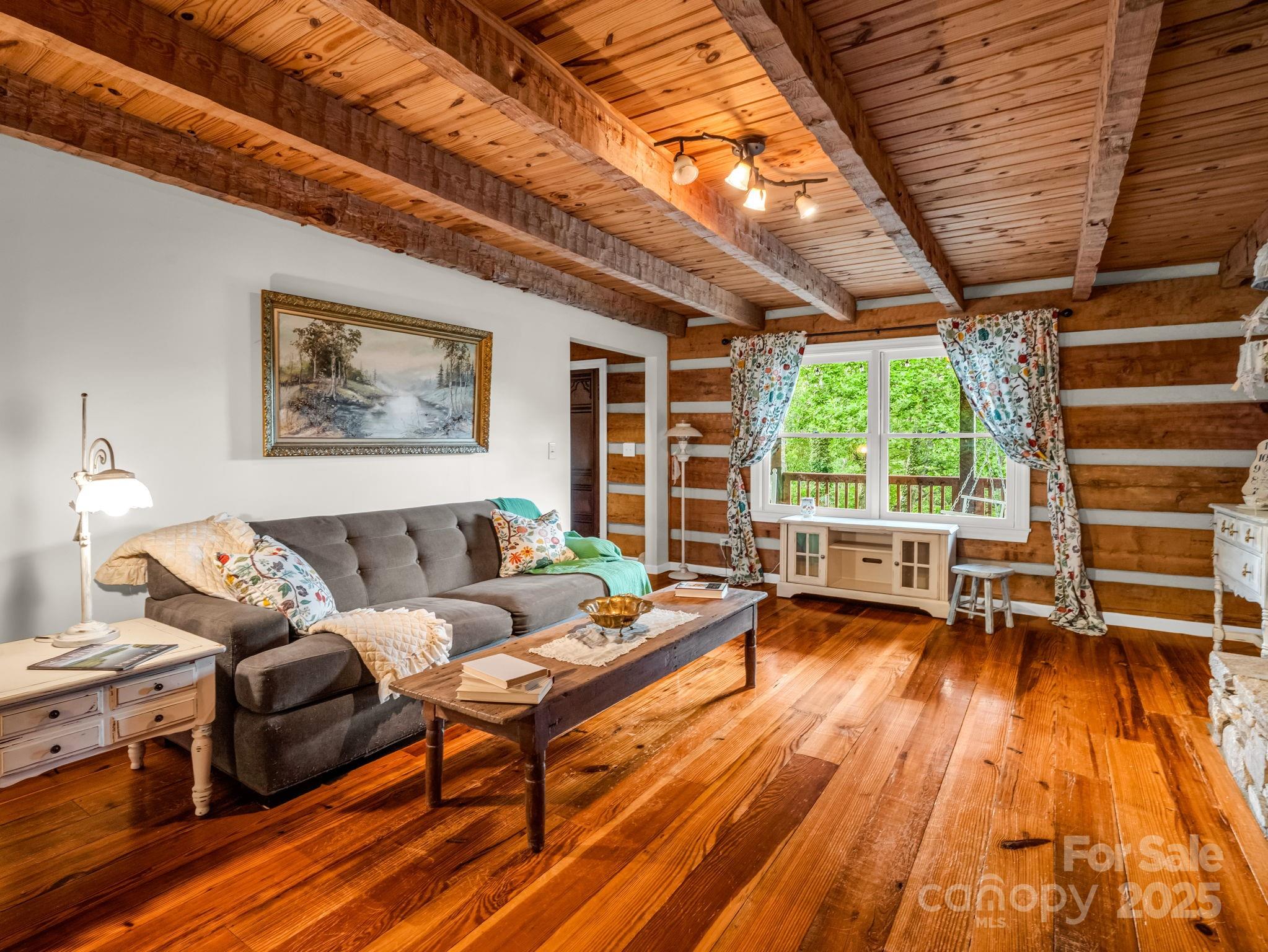 1145 Bearwallow Mountain Road Hendersonville, NC 28792 - Photo 10 of 48 a living room with furniture and a wooden floor