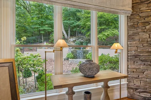 a kitchen with stainless steel appliances kitchen island granite countertop a stove a sink dishwasher and a refrigerator with wooden floor