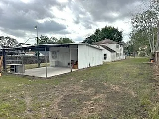 a view of a house with a backyard
