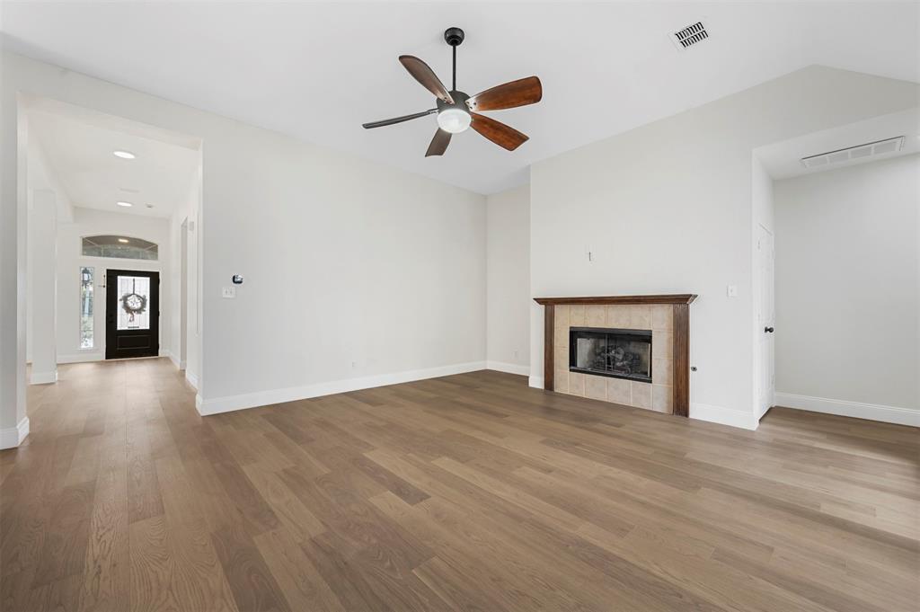 4524 Ridgepointe Drive The Colony, TX 75056 - Photo 12 of 25 a view of an empty room with window and wooden floor