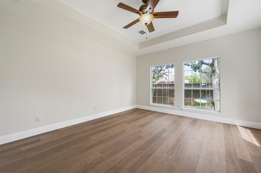 4524 Ridgepointe Drive The Colony, TX 75056 - Photo 13 of 25 a view of an empty room with wooden floor and a window