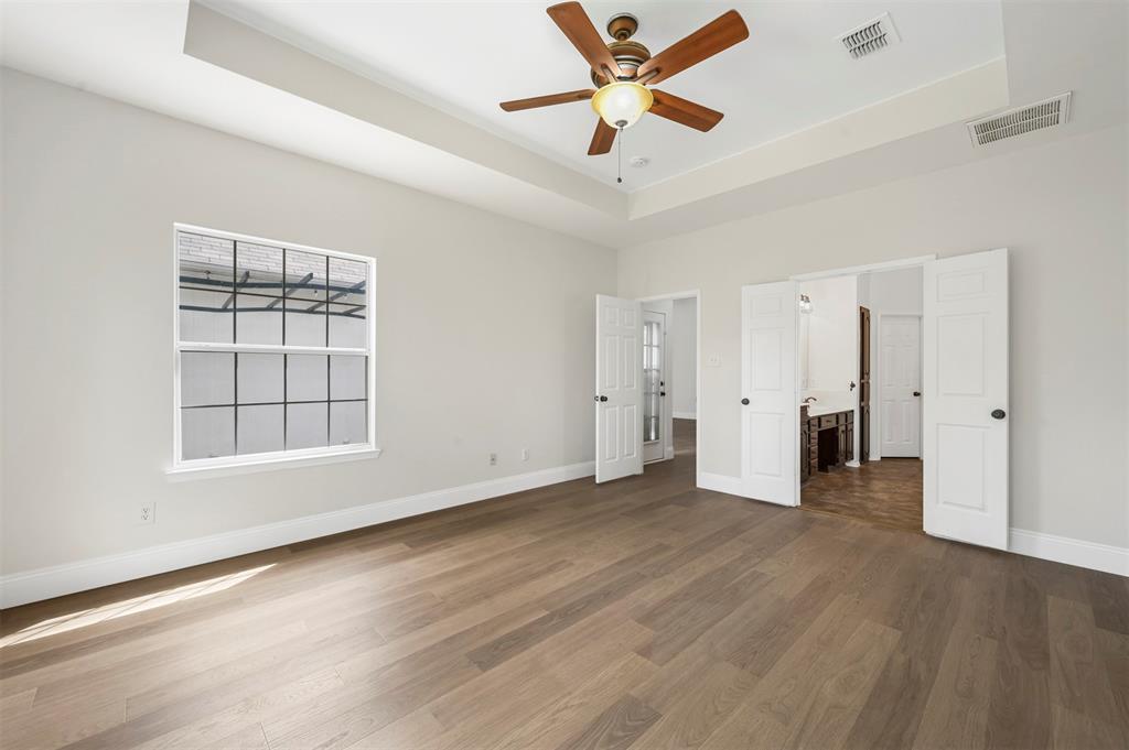 4524 Ridgepointe Drive The Colony, TX 75056 - Photo 14 of 25 an empty room with wooden floor and windows