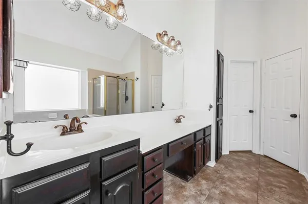 a bathroom with a double vanity sink mirror and