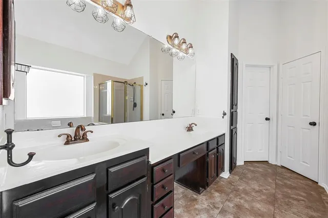 a bathroom with a double vanity sink mirror and