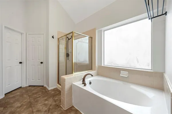a bathroom with a bathtub and a shower