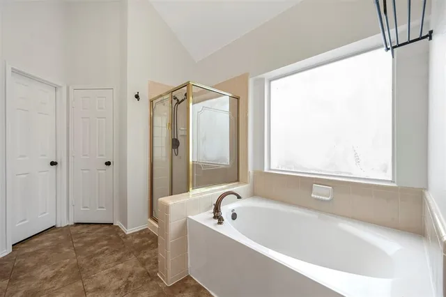 a bathroom with a bathtub and a shower