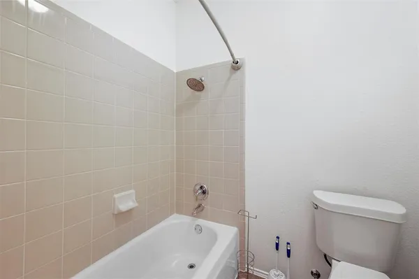 a bathroom with a bathtub and toilet