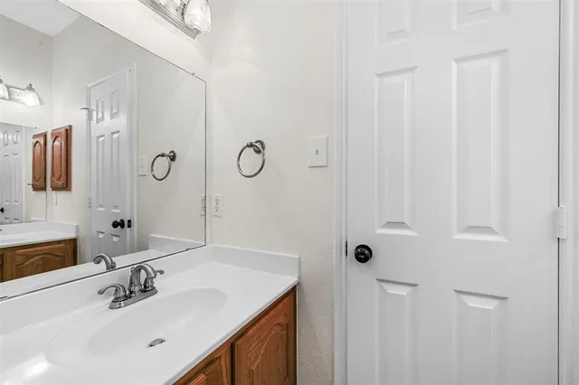 a bathroom with a sink vanity and mirror