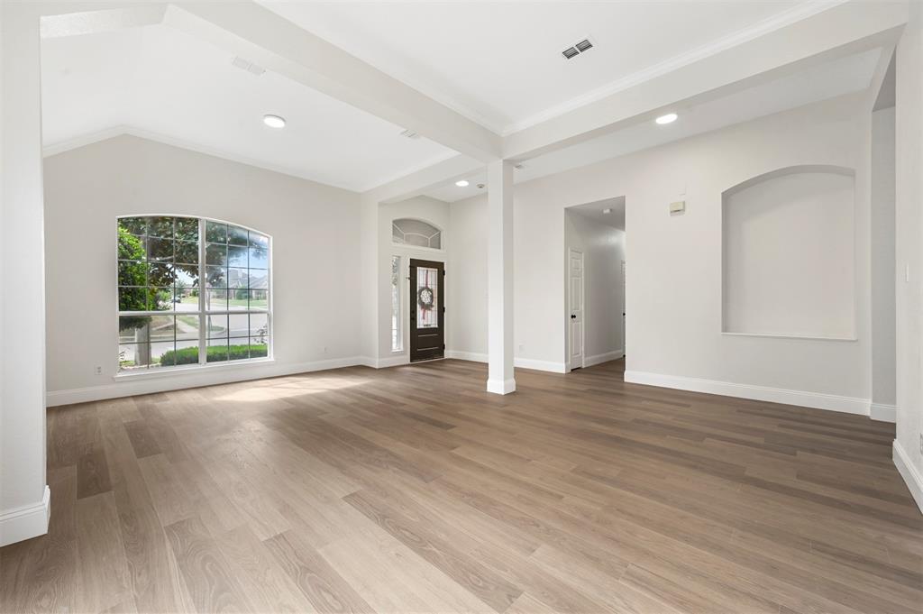 4524 Ridgepointe Drive The Colony, TX 75056 - Photo 2 of 25 a view of an empty room with wooden floor and a window