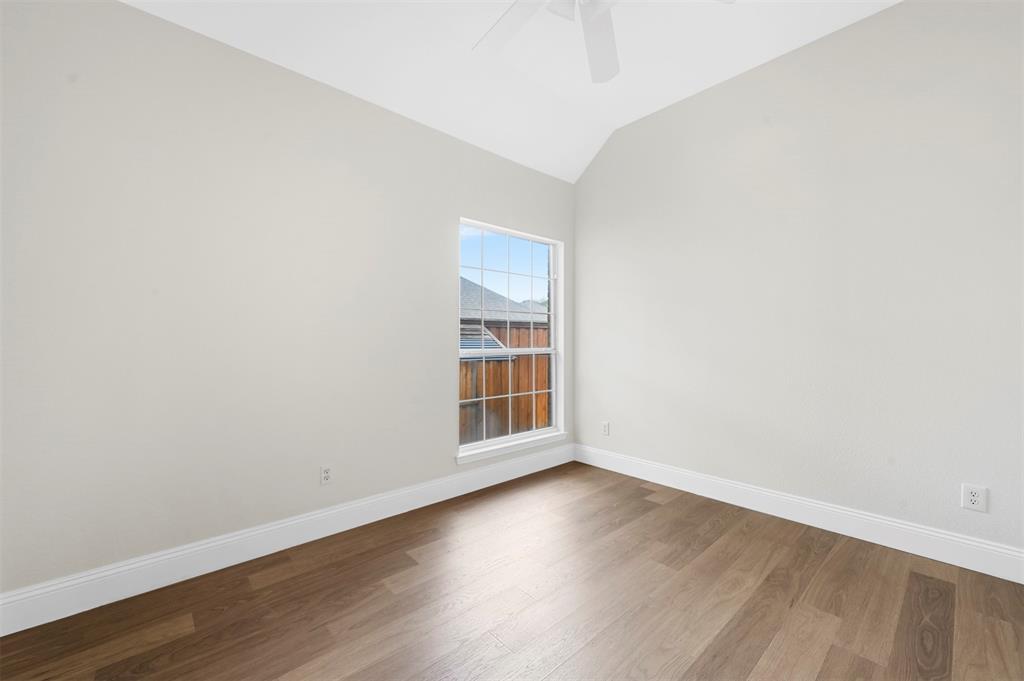 4524 Ridgepointe Drive The Colony, TX 75056 - Photo 22 of 25 an empty room with wooden floor and windows
