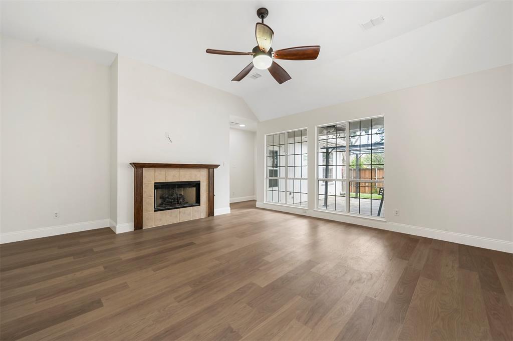 4524 Ridgepointe Drive The Colony, TX 75056 - Photo 10 of 25 a view of an empty room with wooden floor and a window