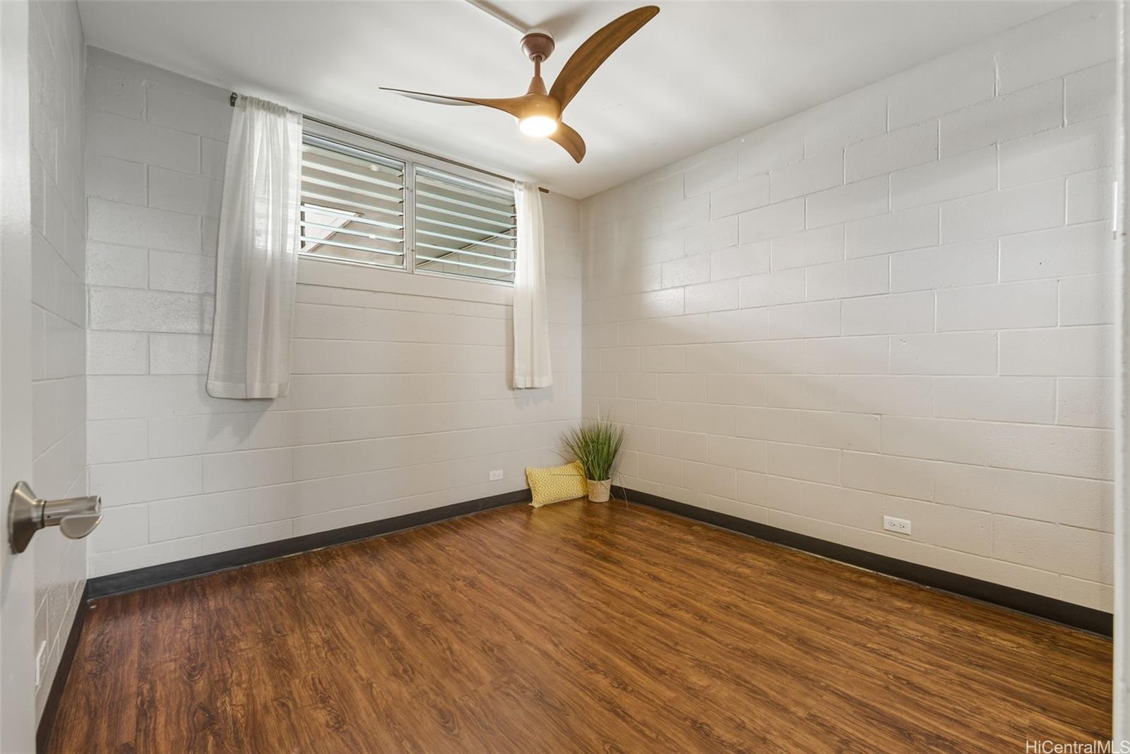 98-135 Lipoa Place, Unit 208 Aiea, HI 96701 - Photo 15 of 22 a view of an empty room with wooden floor and a window