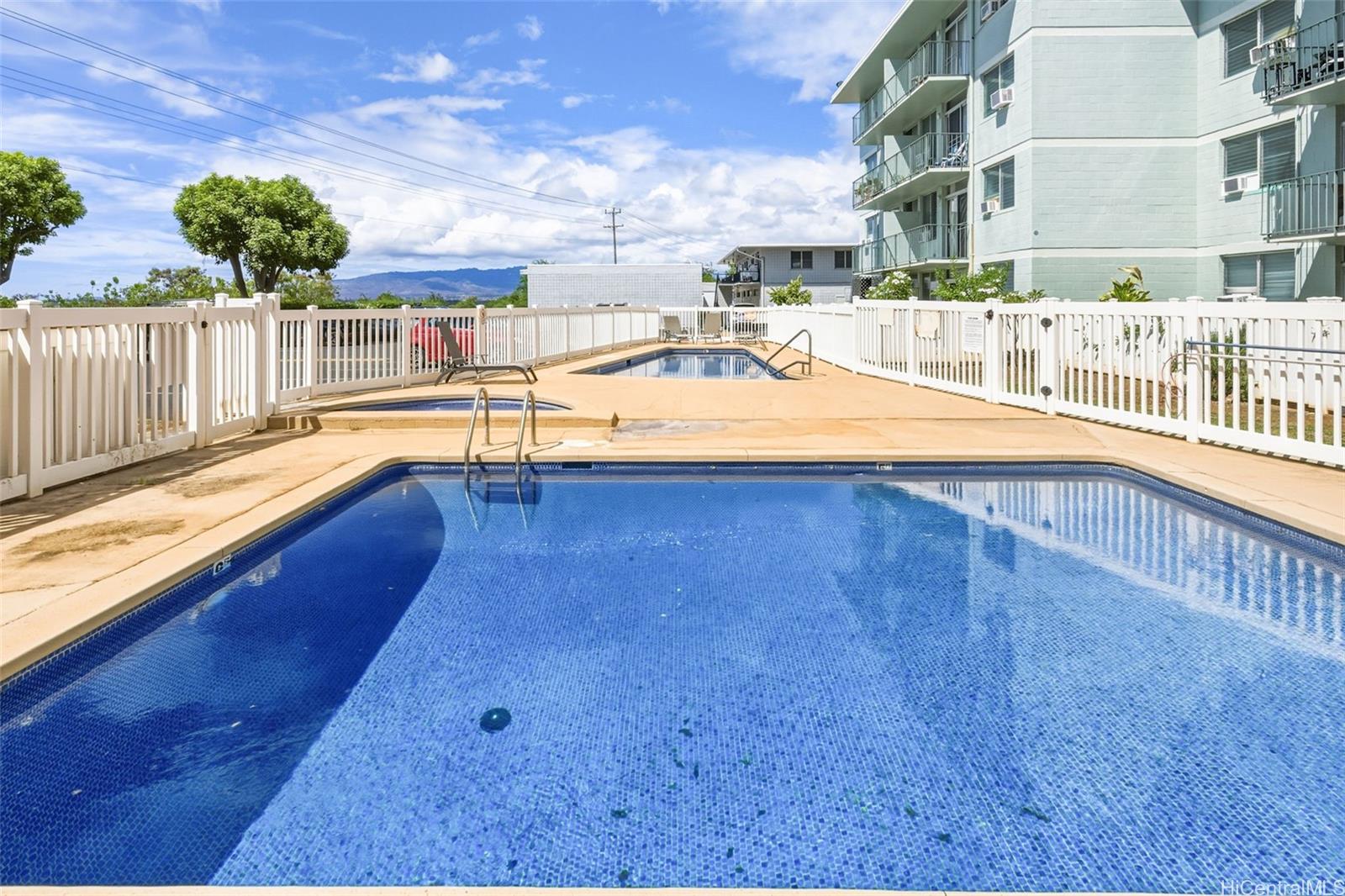 98-135 Lipoa Place, Unit 208 Aiea, HI 96701 - Photo 17 of 22 a view of a swimming pool with a chair