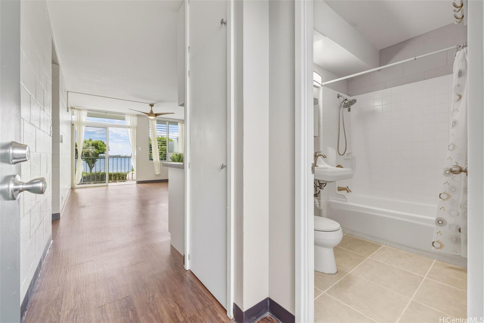 98-135 Lipoa Place, Unit 208 Aiea, HI 96701 - Photo 2 of 22 a view of a bathroom with a tub shower and a sink