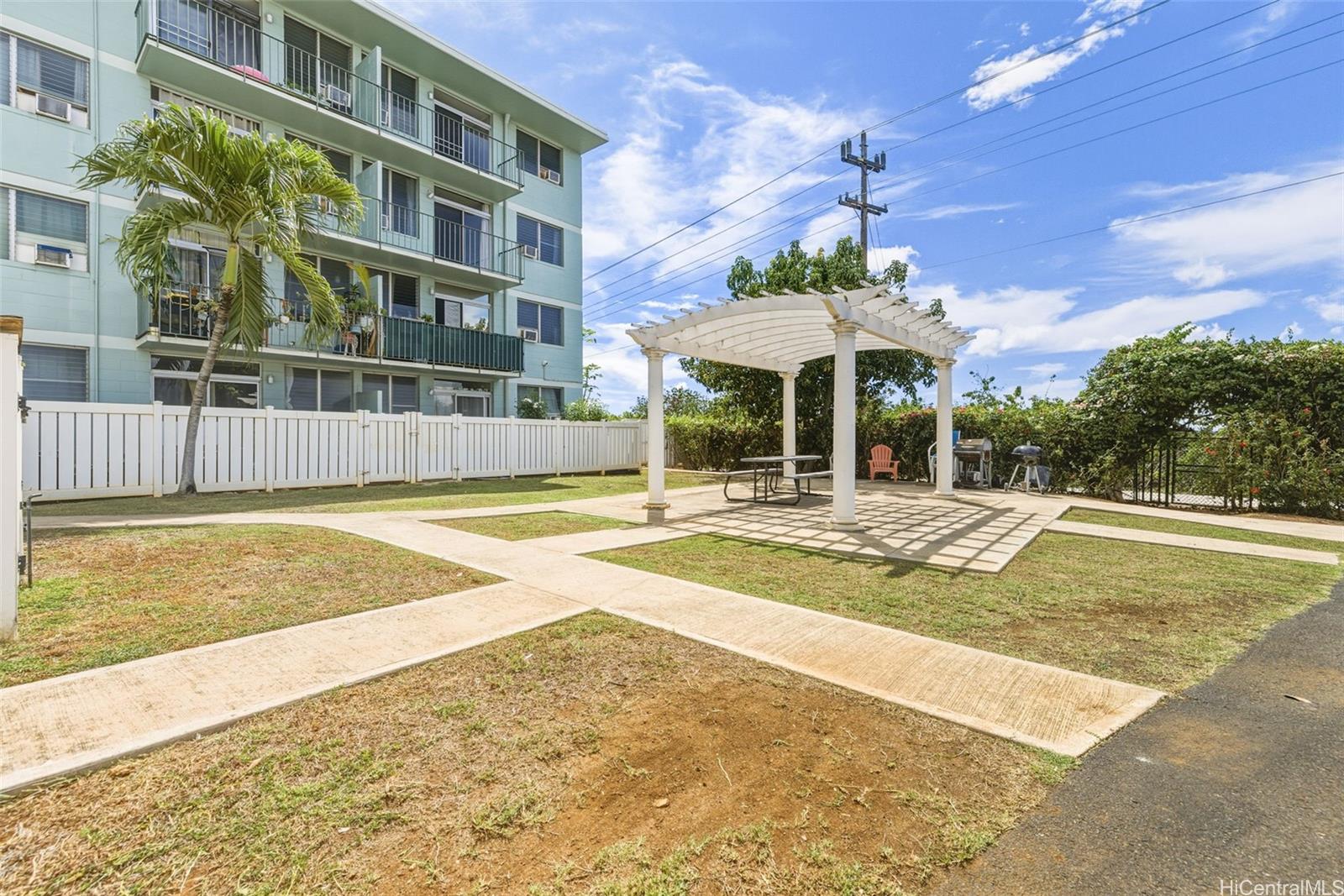 98-135 Lipoa Place, Unit 208 Aiea, HI 96701 - Photo 21 of 22 a view of a swimming pool with a lounge chairs