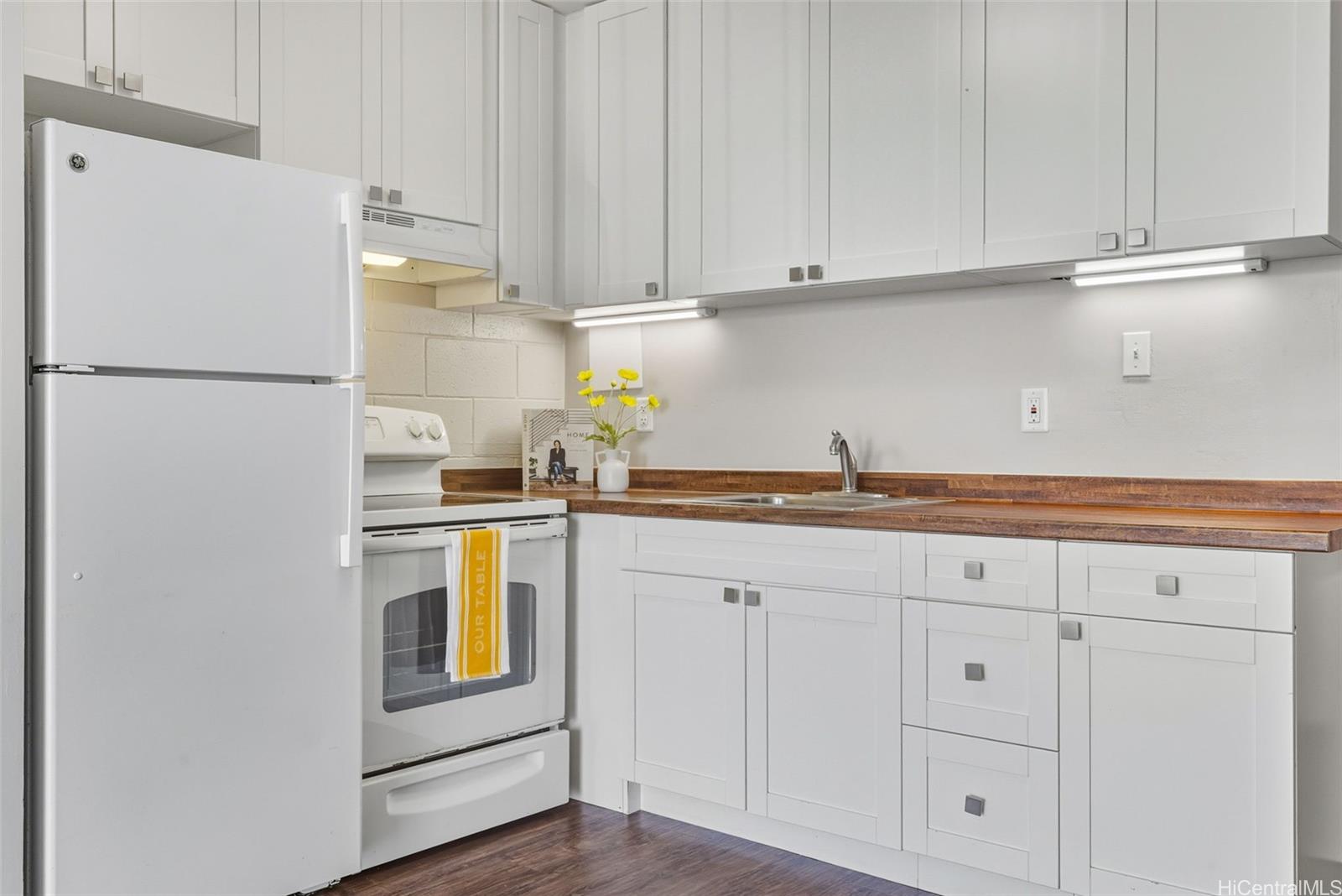 98-135 Lipoa Place, Unit 208 Aiea, HI 96701 - Photo 5 of 22 a kitchen with stainless steel appliances white cabinets and a refrigerator