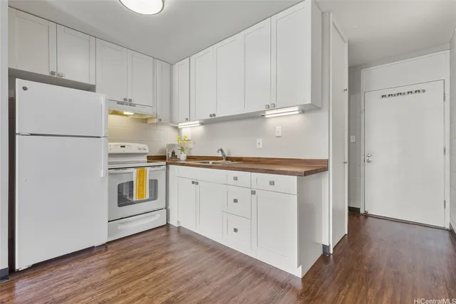 a kitchen with white cabinets and white appliances