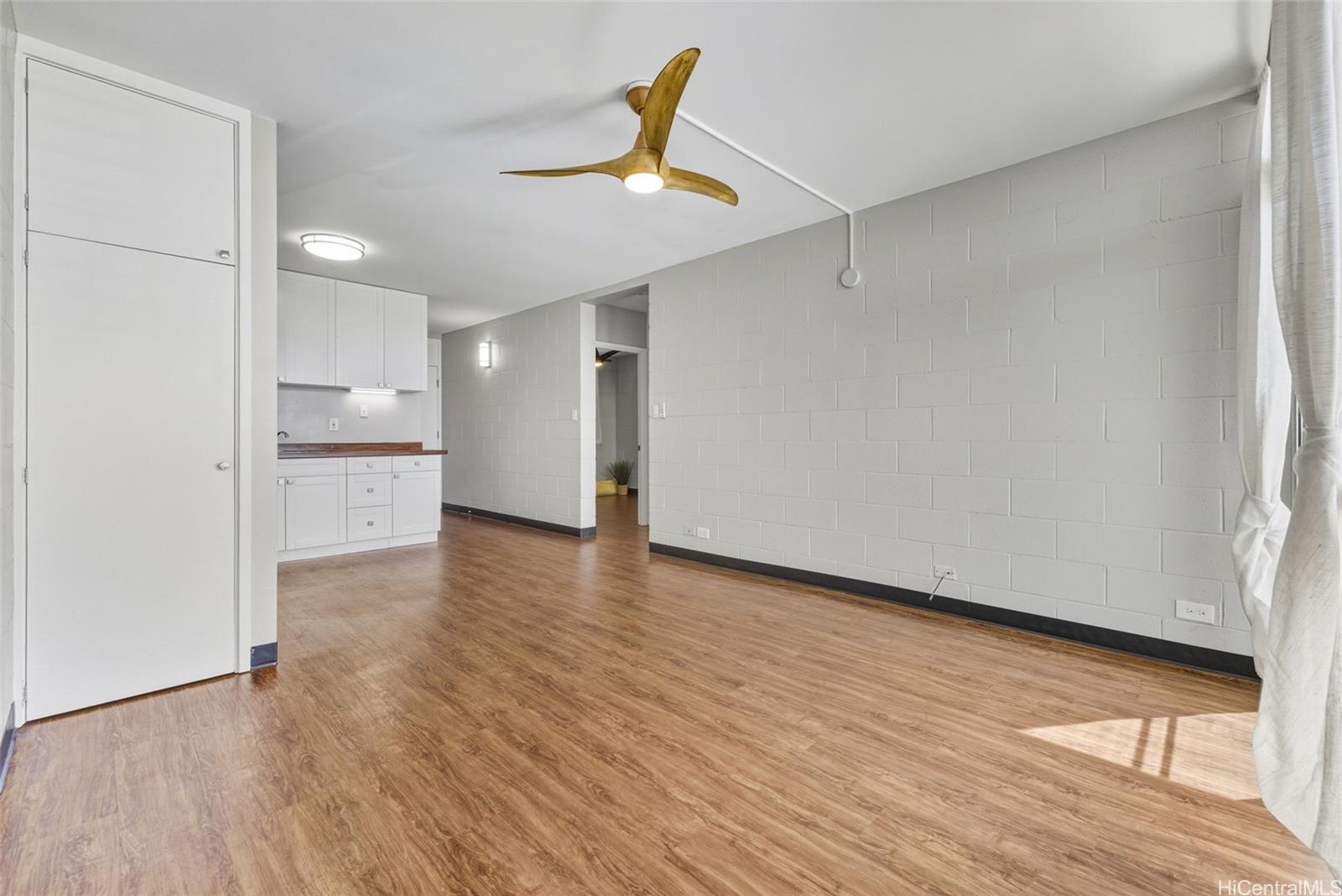 98-135 Lipoa Place, Unit 208 Aiea, HI 96701 - Photo 9 of 22 a view of empty room with wooden floor and window