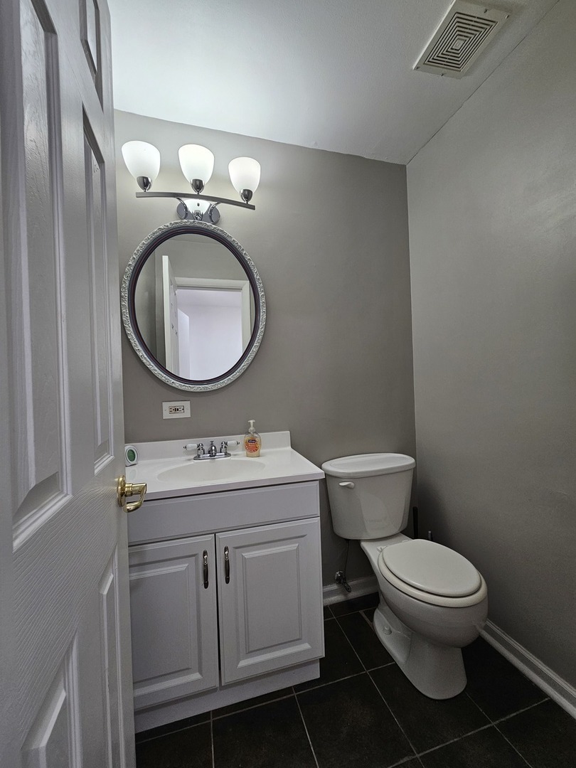 608 Bayview Point Schaumburg, IL 60194 - Photo 10 of 31 a bathroom with a granite countertop toilet a sink and a mirror