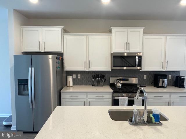 8804 Woodyard Station Road Clinton, MD 20735 - Photo 11 of 39 a kitchen with stainless steel appliances granite countertop a refrigerator a stove a sink and a microwave