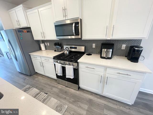 8804 Woodyard Station Road Clinton, MD 20735 - Photo 14 of 39 a kitchen with stainless steel appliances granite countertop a stove a sink and a microwave