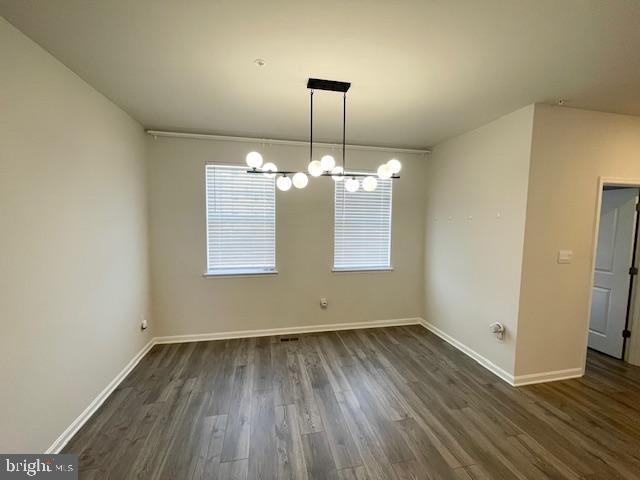 8804 Woodyard Station Road Clinton, MD 20735 - Photo 16 of 39 an empty room with wooden floor chandelier and windows