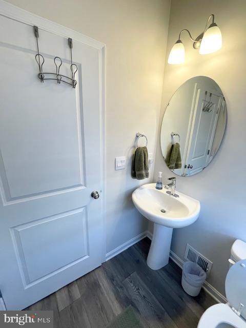 8804 Woodyard Station Road Clinton, MD 20735 - Photo 19 of 39 a bathroom with a toilet sink and mirror